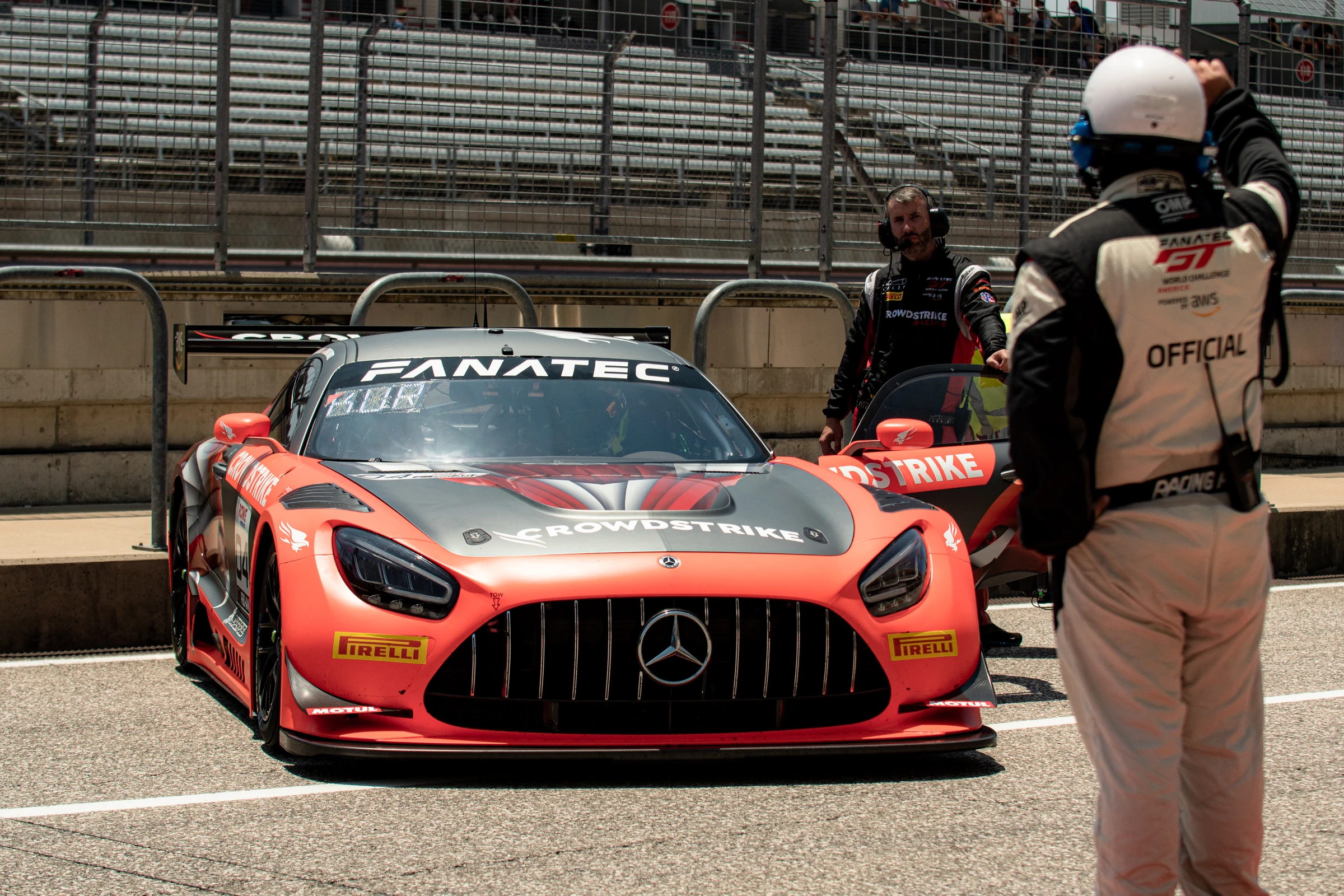 GT World Challenge race car and crew in pit lane