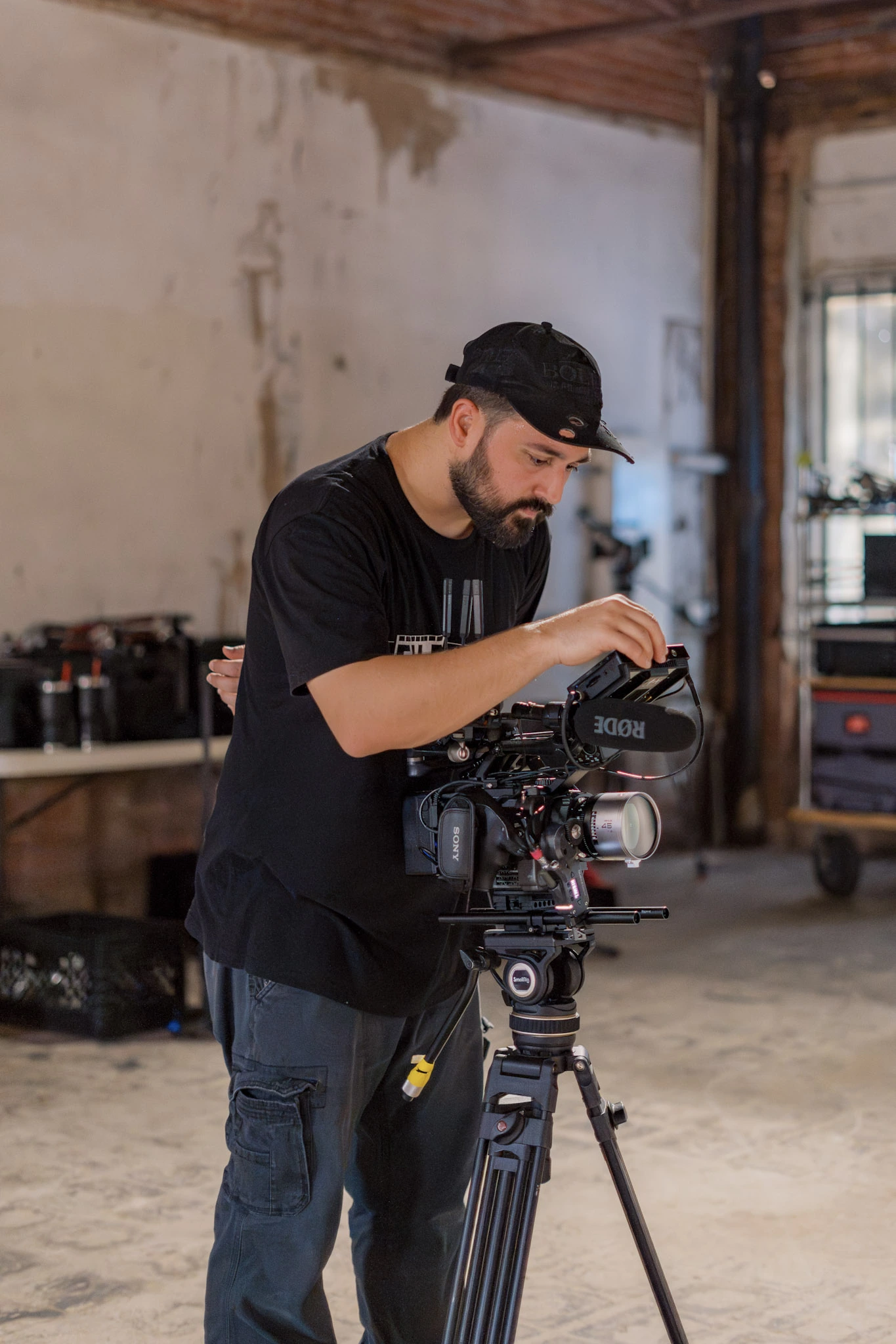 Carlos Neuma adjusting a cinema camera on set